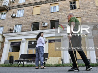 People are staying outside a residential building after the Russian missile attack in Zaporizhzhia, Ukraine, on June 1, 2024. In Zaporizhzhi...