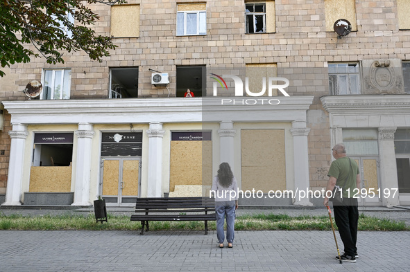 People are staying outside a residential building after the Russian missile attack in Zaporizhzhia, Ukraine, on June 1, 2024. In Zaporizhzhi...