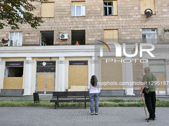 People are staying outside a residential building after the Russian missile attack in Zaporizhzhia, Ukraine, on June 1, 2024. In Zaporizhzhi...