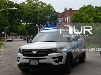 A Chicago police vehicle is blocking the roadway at the crime scene. A 40-year-old male is shot and in critical condition in a shooting in C...