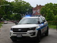 A Chicago police vehicle is blocking the roadway at the crime scene. A 40-year-old male is shot and in critical condition in a shooting in C...