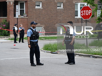 Police officers are gathering at the crime scene for the investigation in Chicago, Illinois, United States, on June 1, 2024. A 40-year-old m...