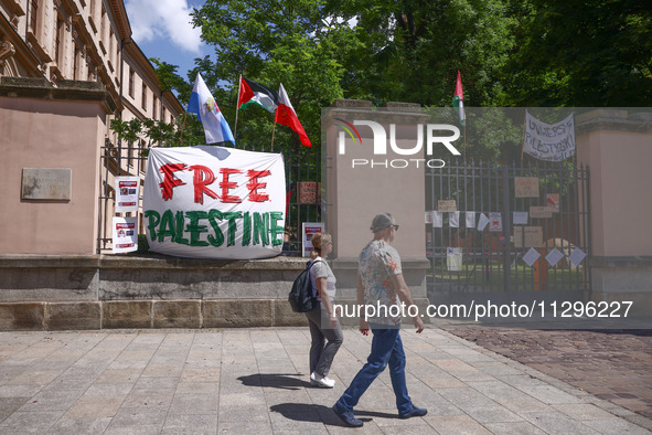 'Free Palestine' banner is seen on a fence while students hold occupational strike in the yard of Jagiellonian University in Krakow, Poland...