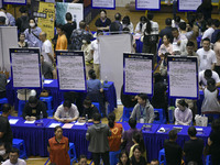 Job seekers are looking for a suitable position at a job fair held by industrial reform enterprises in Huai'an, China, on June 2, 2024. (