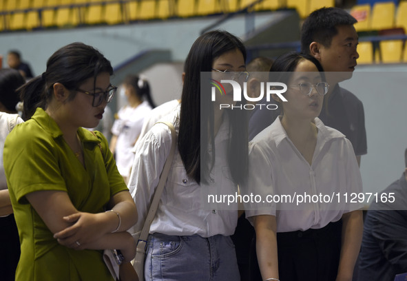 Job seekers are looking for a suitable position at a job fair held by industrial reform enterprises in Huai'an, China, on June 2, 2024. 