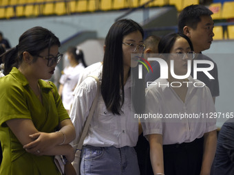 Job seekers are looking for a suitable position at a job fair held by industrial reform enterprises in Huai'an, China, on June 2, 2024. (