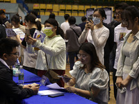 Job seekers are looking for a suitable position at a job fair held by industrial reform enterprises in Huai'an, China, on June 2, 2024. (