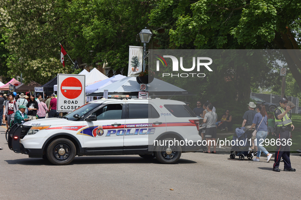 A policeman is diverting oncoming traffic from a closed road in Unionville, Ontario, Canada, on June 03, 2023. 