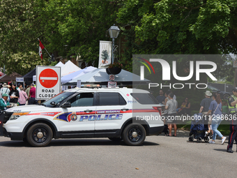 A policeman is diverting oncoming traffic from a closed road in Unionville, Ontario, Canada, on June 03, 2023. (