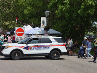 A policeman is diverting oncoming traffic from a closed road in Unionville, Ontario, Canada, on June 03, 2023. (