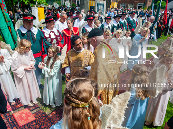 Thousands of people are attending the ''Boxmeerse Vaart,'' an ancient Holy Blood procession, in Boxmeer, Netherlands, on June 2, 2024. (