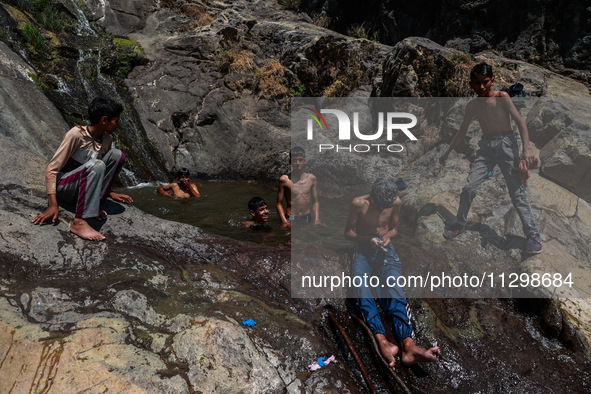 Kashmir boys are taking a bath at a waterfall on a mountain in Hajin, Bandipora, Jammu and Kashmir, India, on June 2, 2024. 61 people are dy...