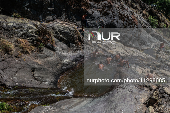 Kashmir boys are taking a bath at a waterfall on a mountain in Hajin, Bandipora, Jammu and Kashmir, India, on June 2, 2024. 61 people are dy...