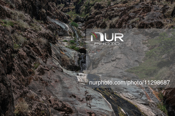 Kashmir boys are taking a bath at a waterfall on a mountain in Hajin, Bandipora, Jammu and Kashmir, India, on June 2, 2024. 61 people are dy...