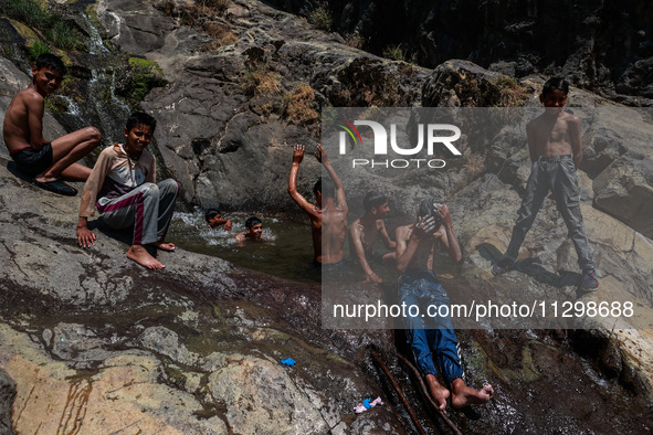 Kashmir boys are taking a bath at a waterfall on a mountain in Hajin, Bandipora, Jammu and Kashmir, India, on June 2, 2024. 61 people are dy...