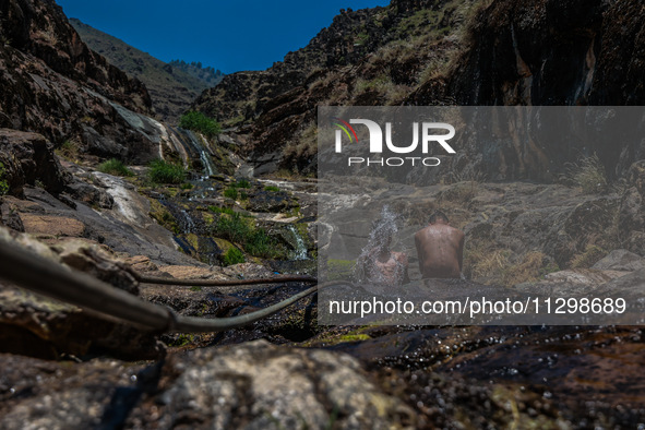 Kashmir boys are taking a bath at a waterfall on a mountain in Hajin, Bandipora, Jammu and Kashmir, India, on June 2, 2024. 61 people are dy...