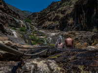 Kashmir boys are taking a bath at a waterfall on a mountain in Hajin, Bandipora, Jammu and Kashmir, India, on June 2, 2024. 61 people are dy...