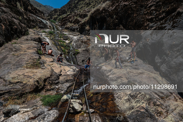 Kashmir boys are taking a bath at a waterfall on a mountain in Hajin, Bandipora, Jammu and Kashmir, India, on June 2, 2024. 61 people are dy...