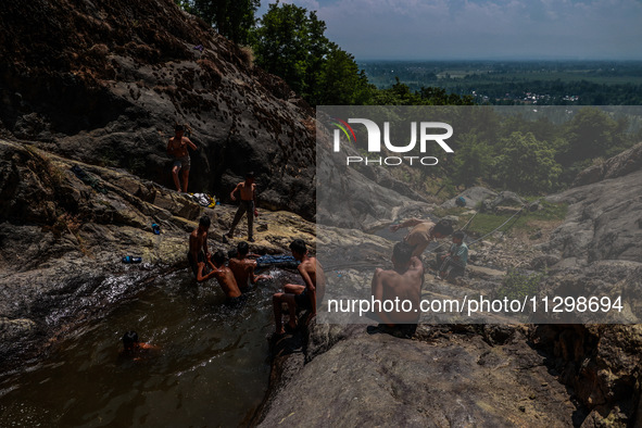 Kashmir boys are taking a bath at a waterfall on a mountain in Hajin, Bandipora, Jammu and Kashmir, India, on June 2, 2024. 61 people are dy...