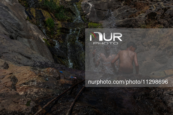 Kashmir boys are taking a bath at a waterfall on a mountain in Hajin, Bandipora, Jammu and Kashmir, India, on June 2, 2024. 61 people are dy...