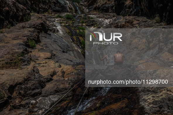 Kashmir boys are taking a bath at a waterfall on a mountain in Hajin, Bandipora, Jammu and Kashmir, India, on June 2, 2024. 61 people are dy...