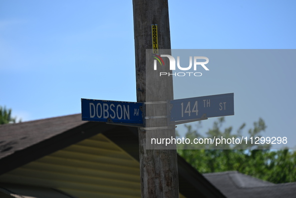 Street signage of Dobson Av where a residence is listed to Mayor of Dolton, Illinois, Tiffany Henyard. Police presence from the Village of D...