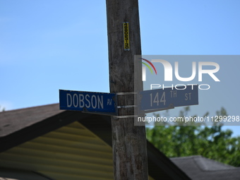 Street signage of Dobson Av where a residence is listed to Mayor of Dolton, Illinois, Tiffany Henyard. Police presence from the Village of D...