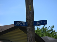 Street signage of Dobson Av where a residence is listed to Mayor of Dolton, Illinois, Tiffany Henyard. Police presence from the Village of D...