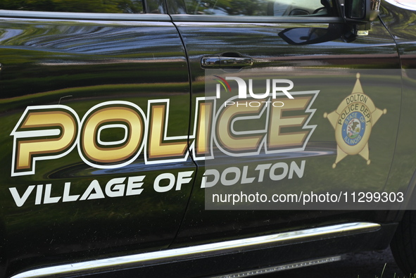 Village of Dolton police signage is on a police vehicle stationed outside a residence listed to Mayor of Dolton, Illinois, Tiffany Henyard....