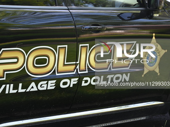 Village of Dolton police signage is on a police vehicle stationed outside a residence listed to Mayor of Dolton, Illinois, Tiffany Henyard....