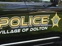 Village of Dolton police signage is on a police vehicle stationed outside a residence listed to Mayor of Dolton, Illinois, Tiffany Henyard....