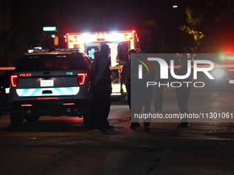 Chicago Police are present and an ambulance is at the scene. A male victim is dying after being shot twenty-five times in a double shooting...