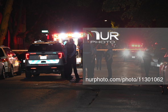 Chicago Police are present and an ambulance is at the scene. A male victim is dying after being shot twenty-five times in a double shooting...