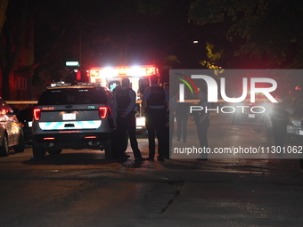 Chicago Police are present and an ambulance is at the scene. A male victim is dying after being shot twenty-five times in a double shooting...