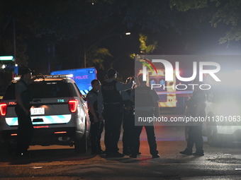 Chicago Police are present and an ambulance is at the scene. A male victim is dying after being shot twenty-five times in a double shooting...