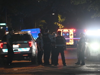 Chicago Police are present and an ambulance is at the scene. A male victim is dying after being shot twenty-five times in a double shooting...