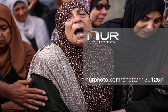 Palestinians are mourning the death of their relatives in an Israeli strike at the Al-Aqsa Martyrs Hospital in Deir al-Balah in the central...