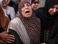 Palestinians are mourning the death of their relatives in an Israeli strike at the Al-Aqsa Martyrs Hospital in Deir al-Balah in the central...