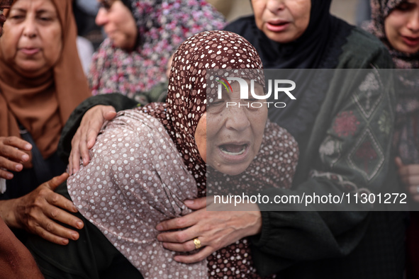 Palestinians are mourning the death of their relatives in an Israeli strike at the Al-Aqsa Martyrs Hospital in Deir al-Balah in the central...