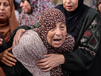 Palestinians are mourning the death of their relatives in an Israeli strike at the Al-Aqsa Martyrs Hospital in Deir al-Balah in the central...