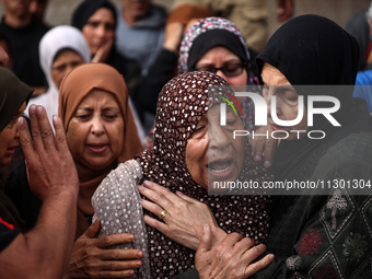 Palestinians are mourning the death of their relatives in an Israeli strike at the Al-Aqsa Martyrs Hospital in Deir al-Balah in the central...