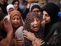 Palestinians are mourning the death of their relatives in an Israeli strike at the Al-Aqsa Martyrs Hospital in Deir al-Balah in the central...