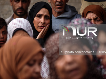 Palestinians are mourning the death of their relatives in an Israeli strike at the Al-Aqsa Martyrs Hospital in Deir al-Balah in the central...