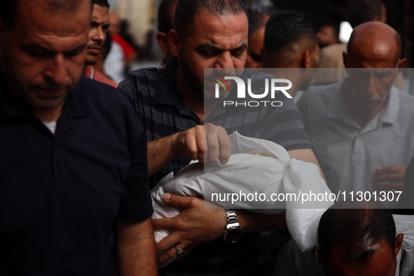 Palestinians are mourning their relatives, killed by an Israeli army strike the previous night, during a funeral at the Al-Aqsa Martyrs Hosp...