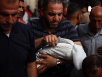 Palestinians are mourning their relatives, killed by an Israeli army strike the previous night, during a funeral at the Al-Aqsa Martyrs Hosp...