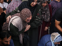 Palestinians are mourning the death of their relatives in an Israeli strike at the Al-Aqsa Martyrs Hospital in Deir al-Balah in the central...