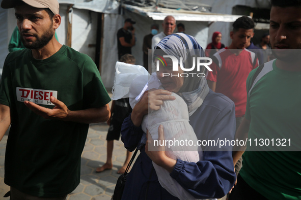 Palestinians are mourning their relatives, killed by an Israeli army strike the previous night, during a funeral at the Al-Aqsa Martyrs Hosp...