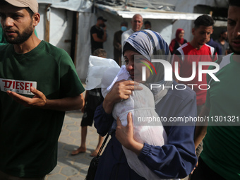 Palestinians are mourning their relatives, killed by an Israeli army strike the previous night, during a funeral at the Al-Aqsa Martyrs Hosp...