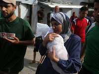 Palestinians are mourning their relatives, killed by an Israeli army strike the previous night, during a funeral at the Al-Aqsa Martyrs Hosp...