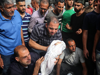 Palestinians are mourning the death of their relatives in an Israeli strike at the Al-Aqsa Martyrs Hospital in Deir al-Balah in the central...